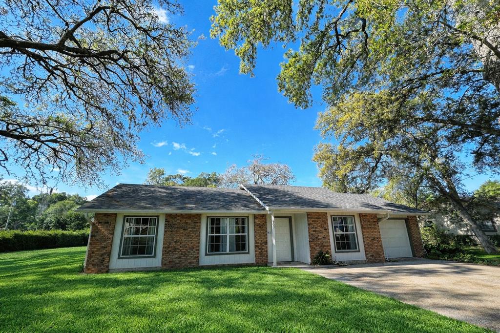 A single-story brick house with a gray shingled roof sits on a grassy lawn — 700 SWARTHMORE ROAD, DELAND, FL