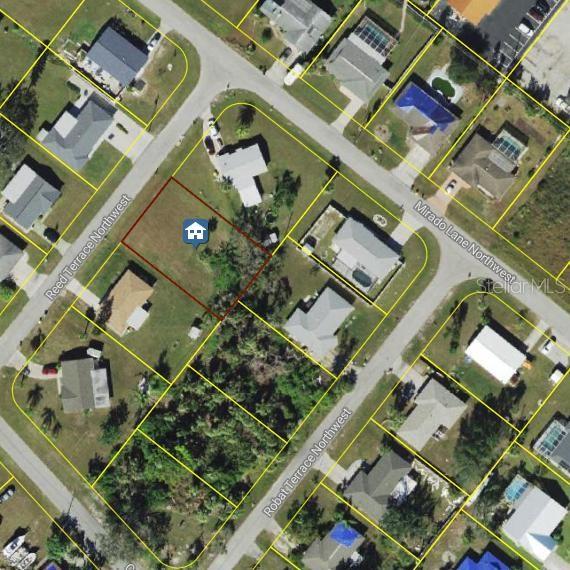 This aerial map shows a vacant residential lot outlined in red within a suburban neighborhood — 1063 REED TERRACE NW, PORT CHARLOTTE, FL