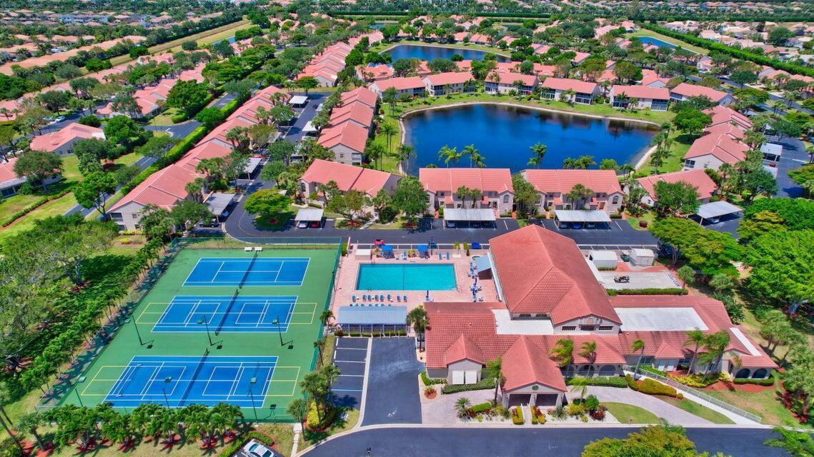 An aerial view shows a community with tennis courts, a swimming pool, and residential buildings — 7922 Sandy Pointe Drive, Delray Beach FL 33446, DELRAY BEACH, FL