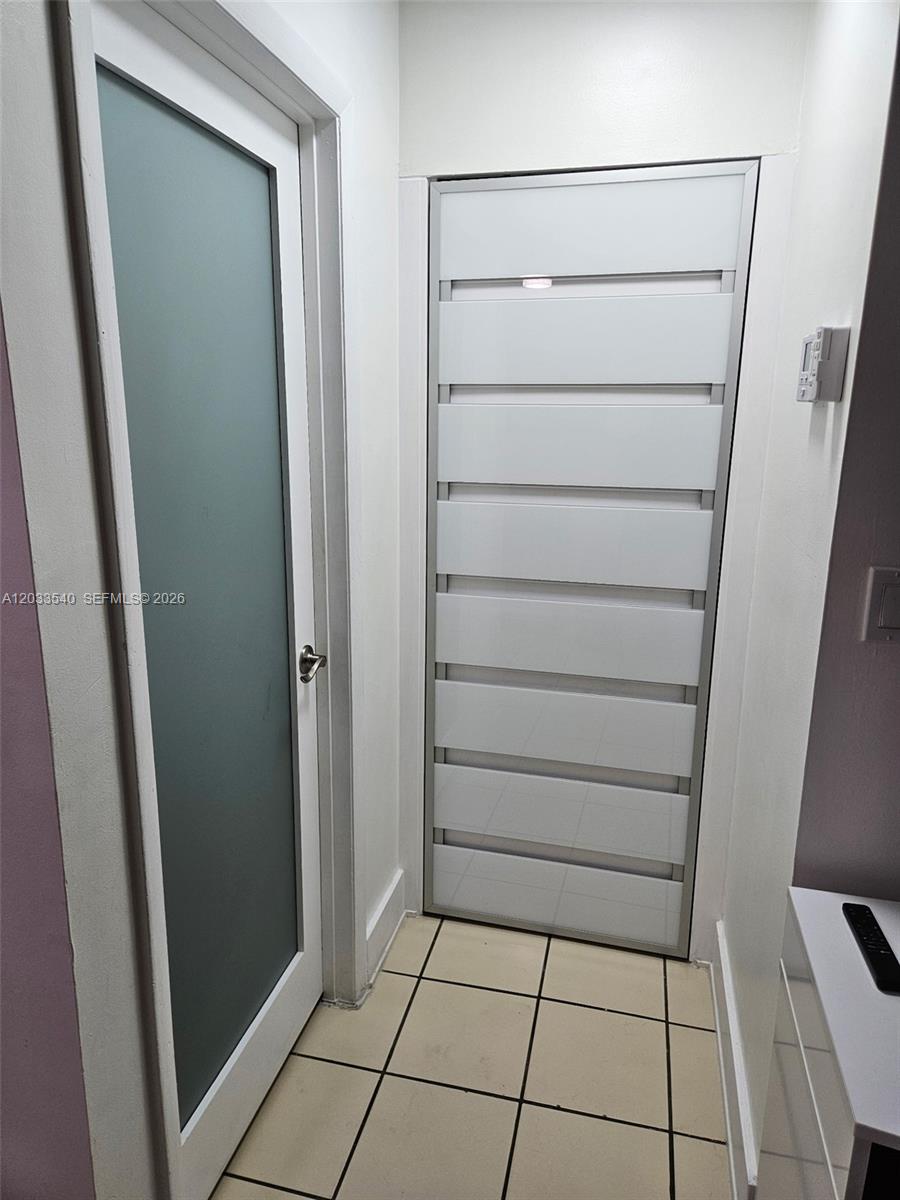 A hallway features a frosted glass door and a white paneled door with horizontal slats — 2348 W 56th St # 19, Hialeah FL 33016, HIALEAH, FL