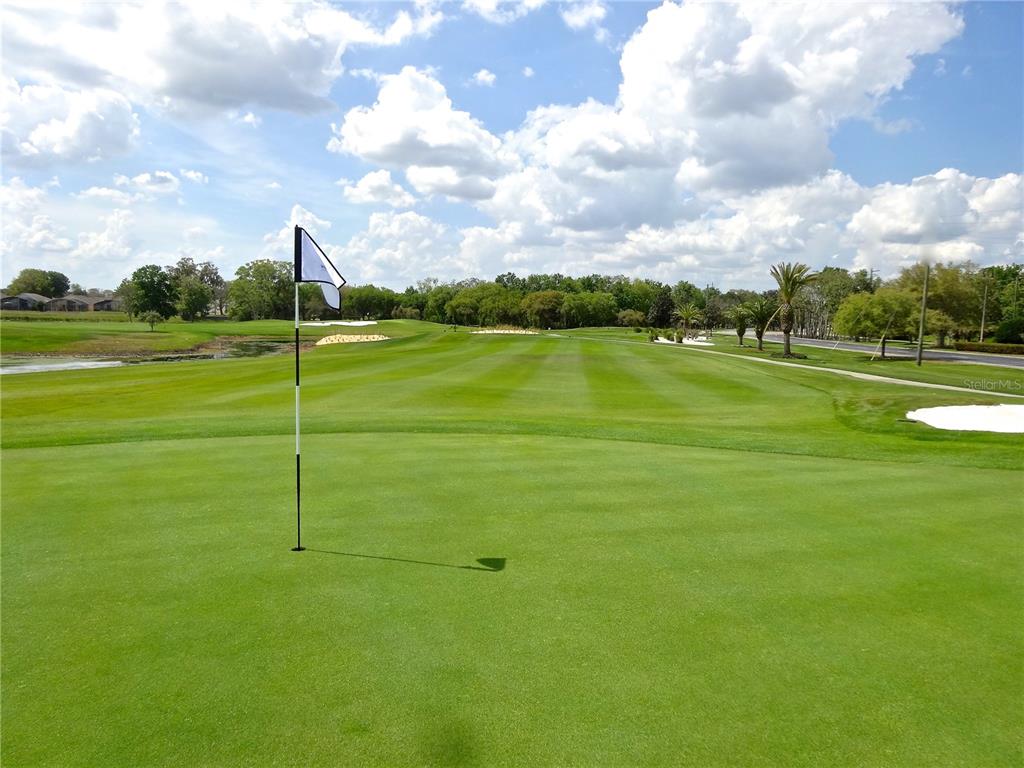 A view from a golf course putting green looking down the fairway toward trees — 200 EAGLE RIDGE DRIVE, DAVENPORT, FL