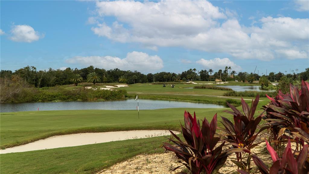 A view of a golf course green with a sand bunker and a water hazard — 200 EAGLE RIDGE DRIVE, DAVENPORT, FL