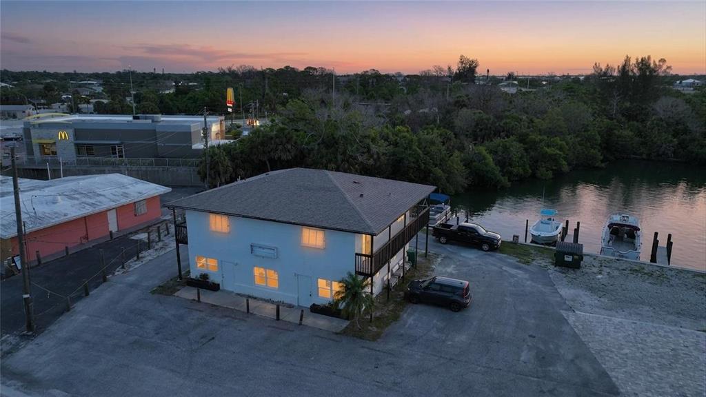 An aerial view of a two-story building near a canal with boats and a McDonald's — 1261 BEACH ROAD, ENGLEWOOD, FL