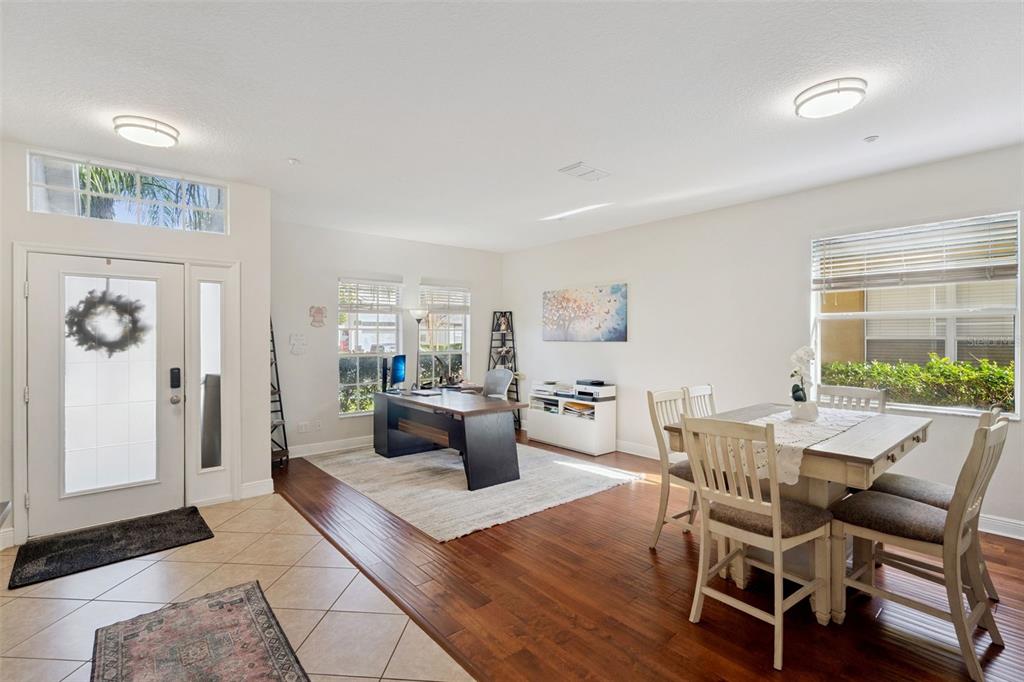 A combined home office and dining area features hardwood floors, tile entry, and white walls — 9310 MUSTARD LEAF DRIVE, ORLANDO, FL