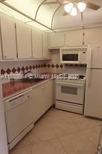 A kitchen with white cabinets, a dishwasher, a stove, and a microwave — 198 E Mansfield  E # 198, Boca Raton FL 33434, BOCA RATON, FL