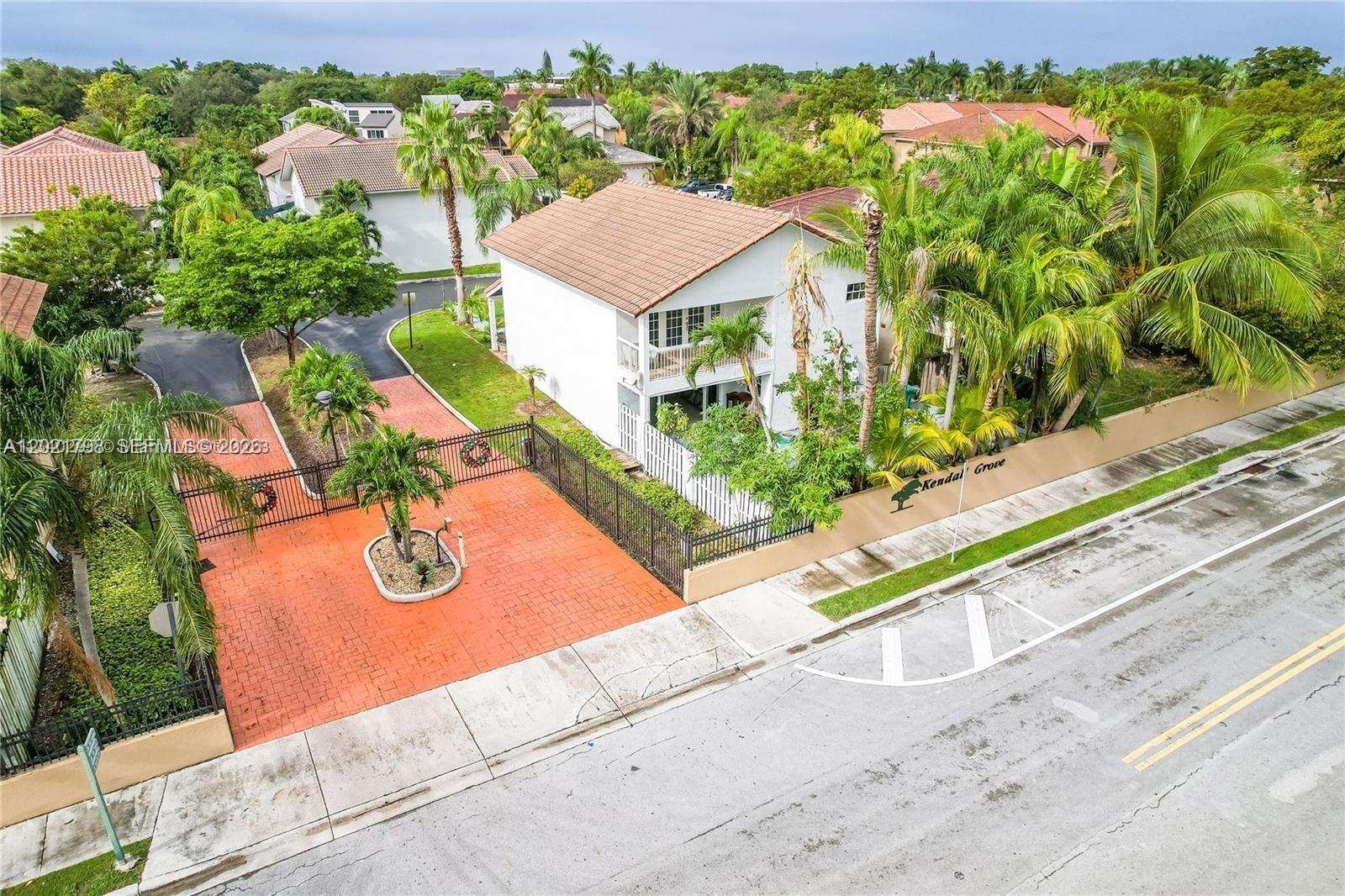 An aerial view shows a white two-story house with a red-tiled roof and gated driveway — 8909 SW 108th Cir Ct, Miami FL 33176, MIAMI, FL