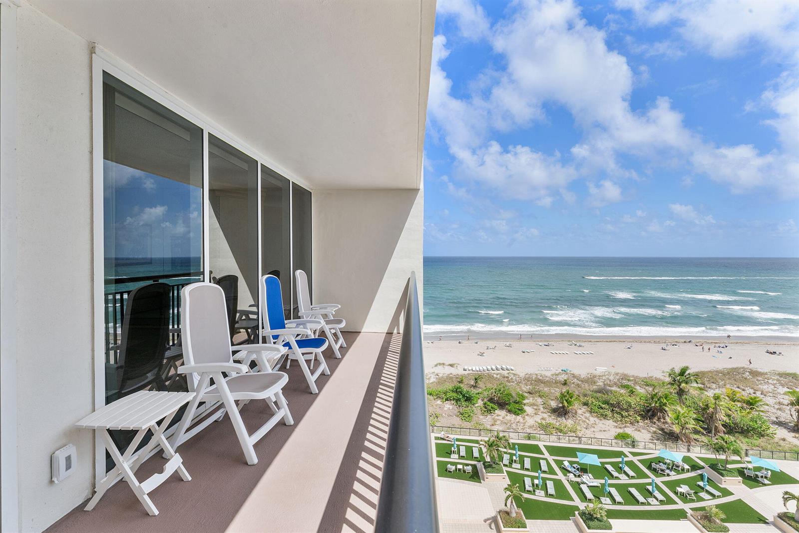 A balcony with white chairs overlooks a sandy beach and the ocean — 2000 S Ocean Boulevard # 10h, Boca Raton FL 33432, BOCA RATON, FL