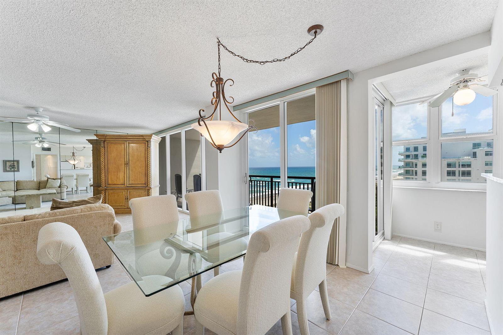 A dining area with a glass table, upholstered chairs, and a view of the ocean — 2000 S Ocean Boulevard # 10h, Boca Raton FL 33432, BOCA RATON, FL