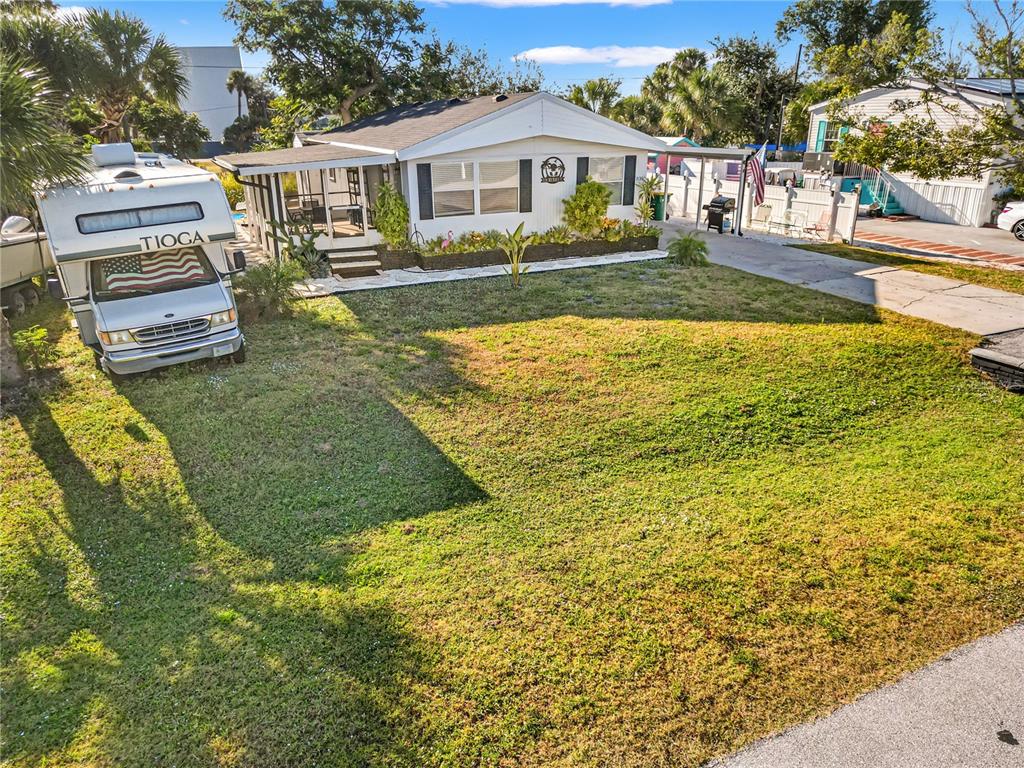 An exterior view of a single-story home with a parked RV in the front yard — 3130 BOURBON STREET, ENGLEWOOD, FL