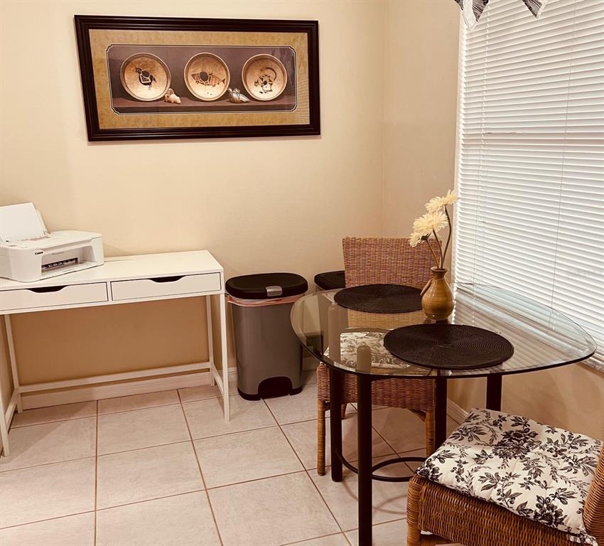 A small dining area features a glass-topped table with wicker chairs and a white desk — 9620 CLUB SOUTH CIRCLE UNIT 5101, SARASOTA, FL