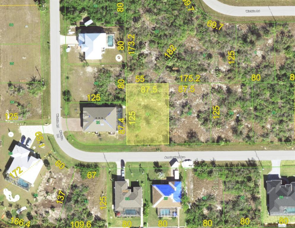 This is a satellite map showing a highlighted vacant residential lot in a suburban neighborhood — 14988 AMSTERDAM AVENUE, PORT CHARLOTTE, FL