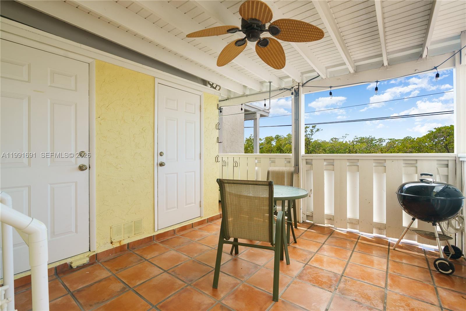 A covered outdoor patio features terracotta tile flooring, a ceiling fan, and a small grill — 1500 Ocean Bay Dr # F5, Key Largo FL 33037, KEY LARGO, FL