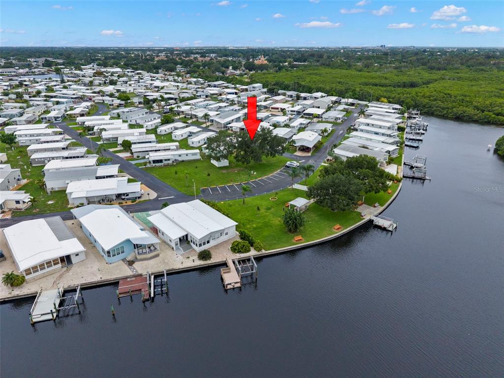 A light green mobile home features a large carport and a landscaped front yard — 684 MOUNT LANCASTER AVENUE NE UNIT 644, ST PETERSBURG, FL