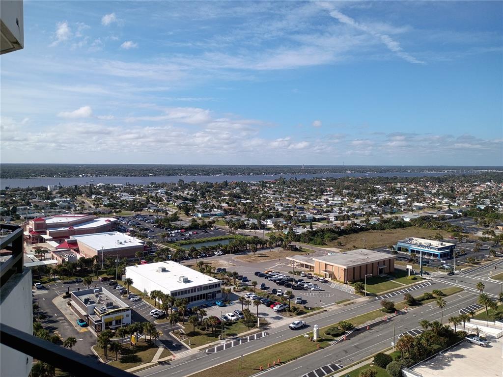 An elevated view shows a suburban landscape with commercial buildings, parking lots, and a river — 2900 N ATLANTIC AVENUE UNIT 2001, DAYTONA BEACH, FL