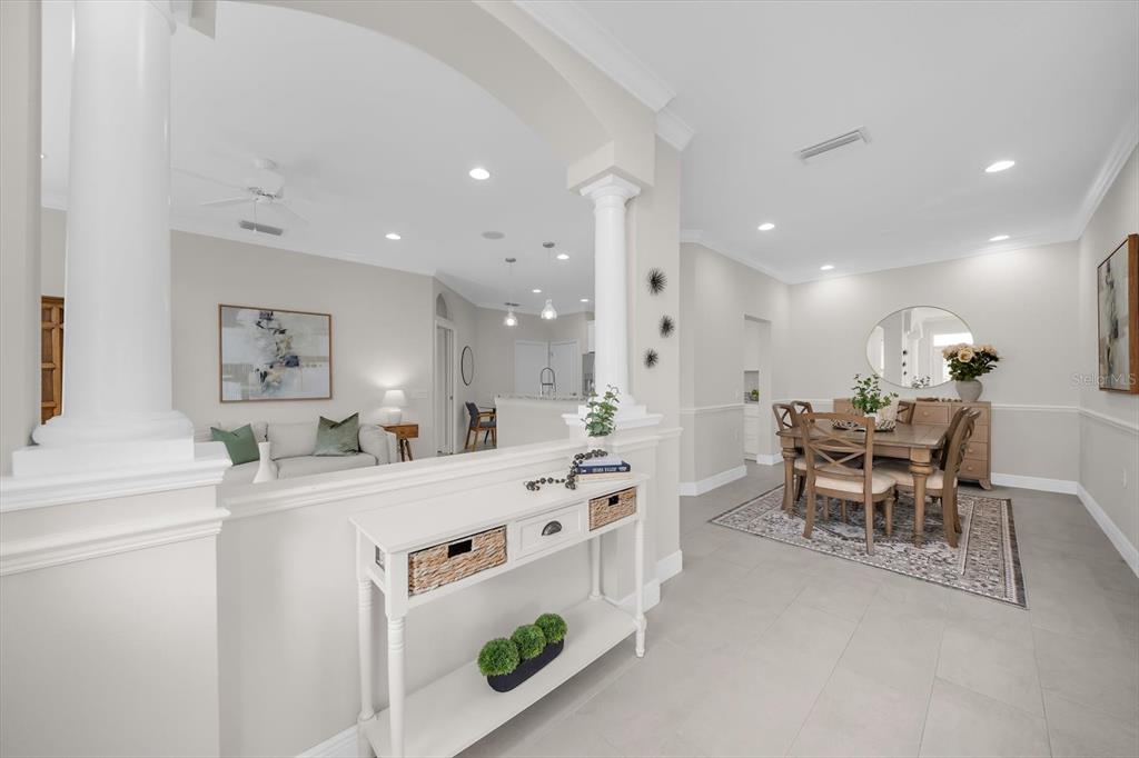 A white console table sits in front of a dining area and a living room — 6942 WOODMORE TERRACE, LAKEWOOD RANCH, FL
