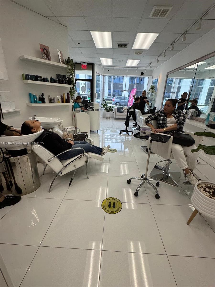 A hair salon interior features white tile floors, styling chairs, and a shampoo station — BAY HARBOUR, Bay Harbor Islands FL 33154, BAY HARBOR ISLANDS, FL
