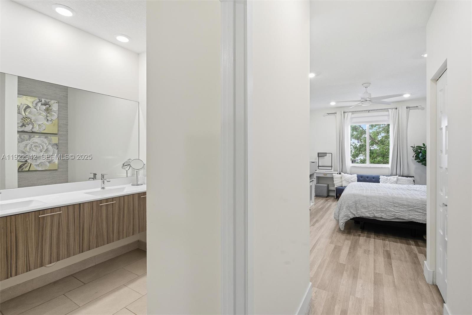 A bathroom with a double vanity and a bedroom with a bed are visible — 6420 NW 102nd Path # 110, Doral FL 33178, DORAL, FL