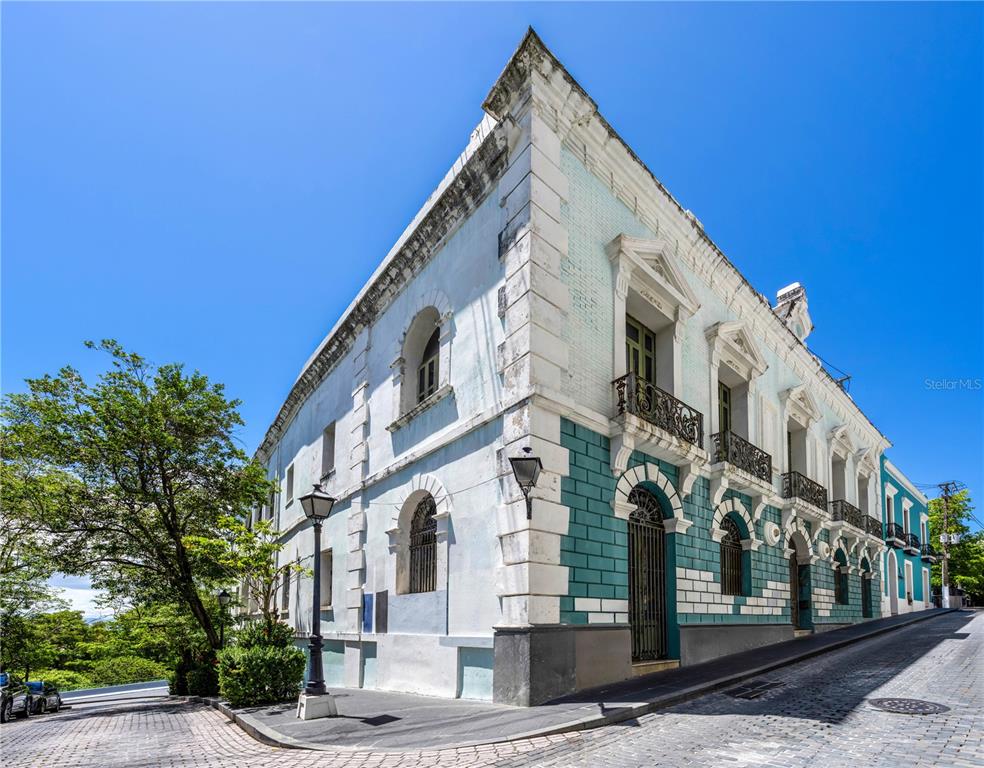 A corner view of a historic multi-story building with teal and white masonry on a street — 152 TETUAN STREET, SAN JUAN, PR