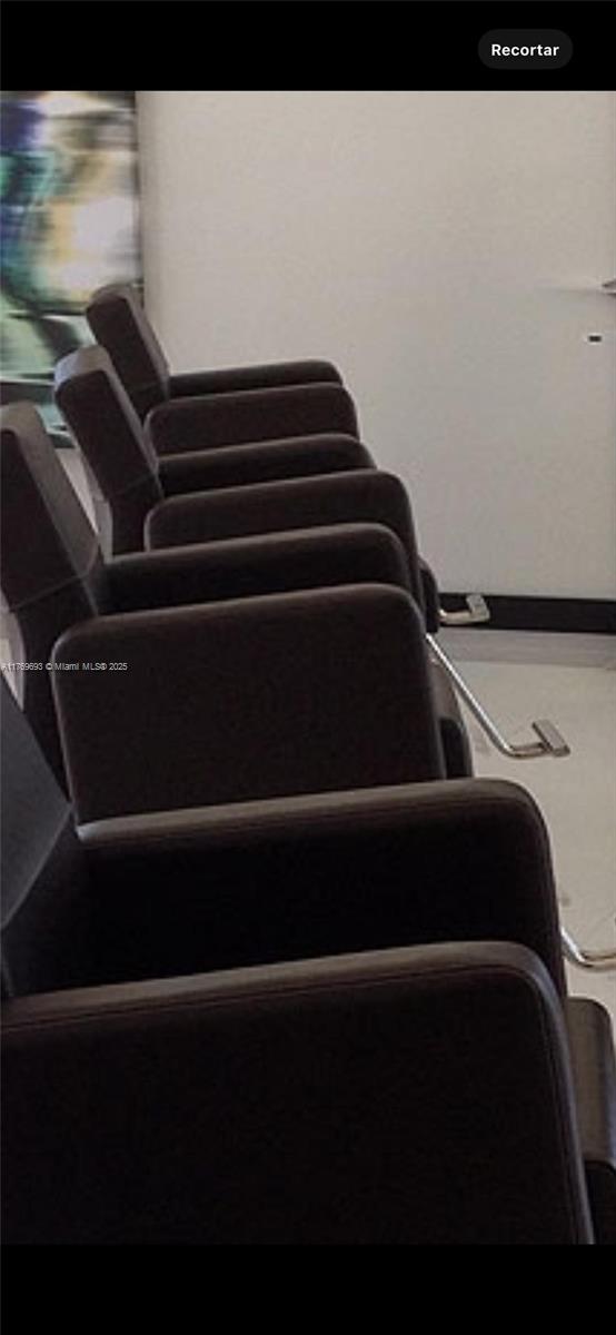 A row of dark brown chairs is arranged in a line against a white wall — NW 36 ST, Doral FL 33122, DORAL, FL