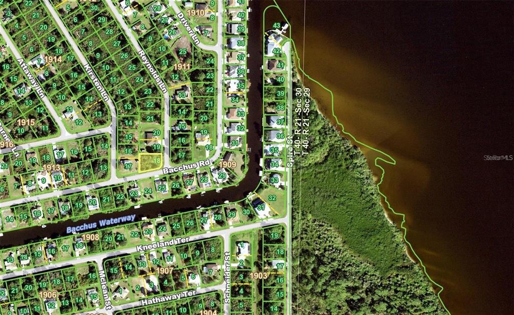 This is an aerial map showing residential lots, streets, and a waterway — 12739 BACCHUS ROAD, PORT CHARLOTTE, FL