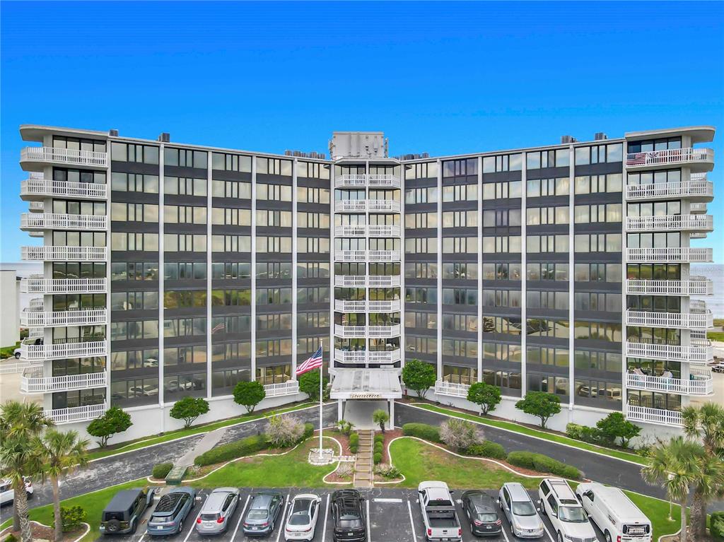 An aerial view of a multi-story apartment building with balconies and a parking lot — 3580 S OCEAN SHORE BOULEVARD UNIT 506, FLAGLER BEACH, FL