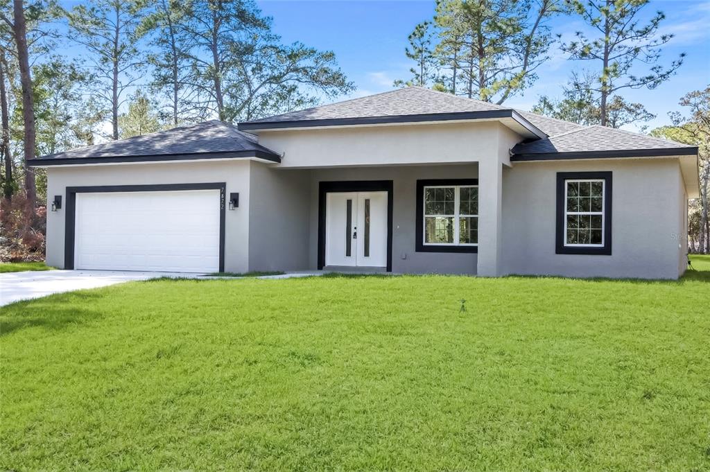 A single-story house with a gray stucco exterior, black trim, and a two-car garage — 7872 N KEYSTONE DRIVE, CITRUS SPRINGS, FL