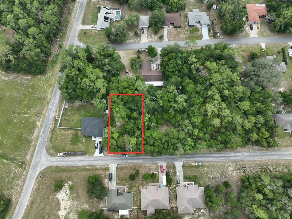 An aerial view shows a rectangular, wooded vacant lot outlined in red along a road — 2184 W SUMMER PLACE, CITRUS SPRINGS, FL