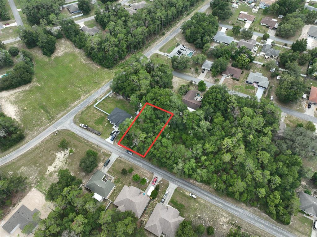 An aerial view shows a rectangular, wooded vacant lot outlined in red along a road — 2184 W SUMMER PLACE, CITRUS SPRINGS, FL