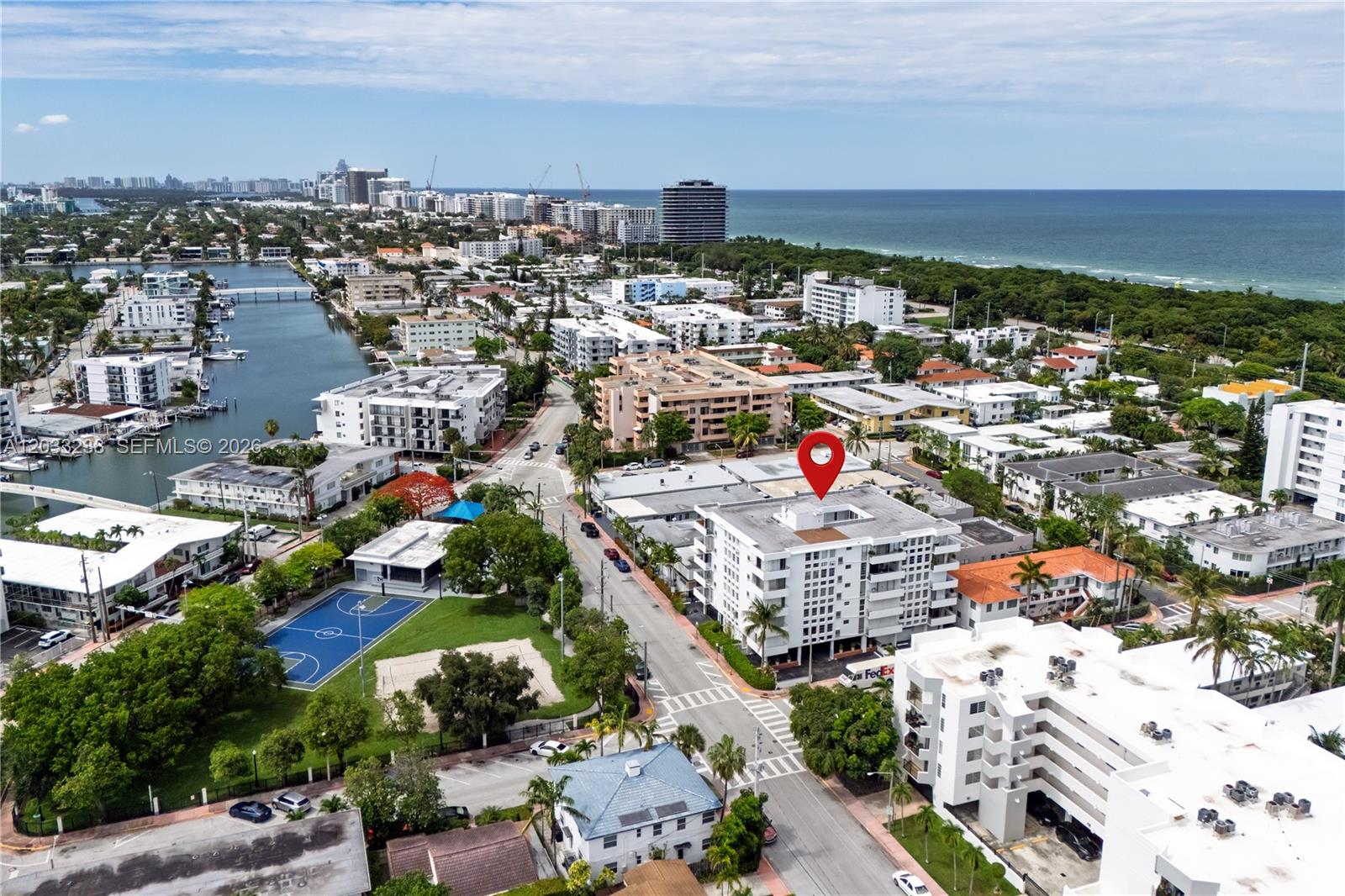 An aerial view shows a multi-story apartment building marked with a red pin near water — 8001 Byron Ave # 3C, Miami Beach FL 33141, MIAMI BEACH, FL