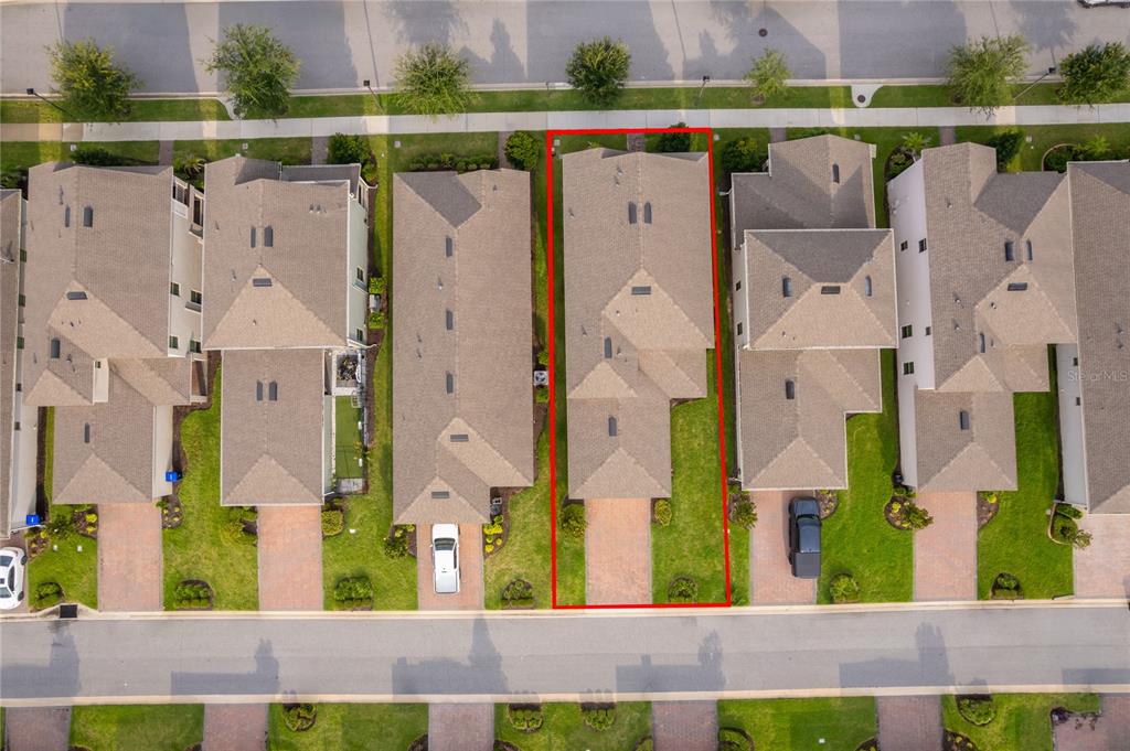 An aerial view shows a single-family home outlined in red within a suburban neighborhood — 9445 KOMIKA LANE, WINTER GARDEN, FL