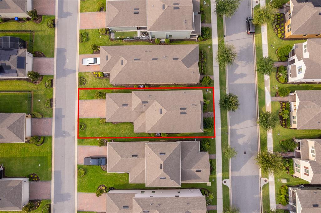 An aerial view shows a single-family home outlined in red within a suburban neighborhood — 9445 KOMIKA LANE, WINTER GARDEN, FL