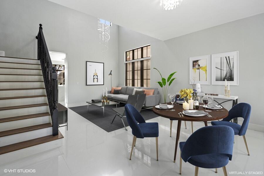 This virtually staged living and dining area features high ceilings, a staircase, and tile flooring — 9648 Ginger Court, Parkland FL 33076, PARKLAND, FL