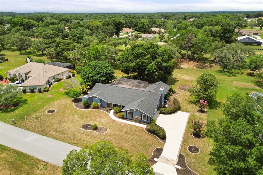 A single-story house with gray siding, stone accents, and a dark shingled roof — 751 E GILCHRIST COURT, HERNANDO, FL