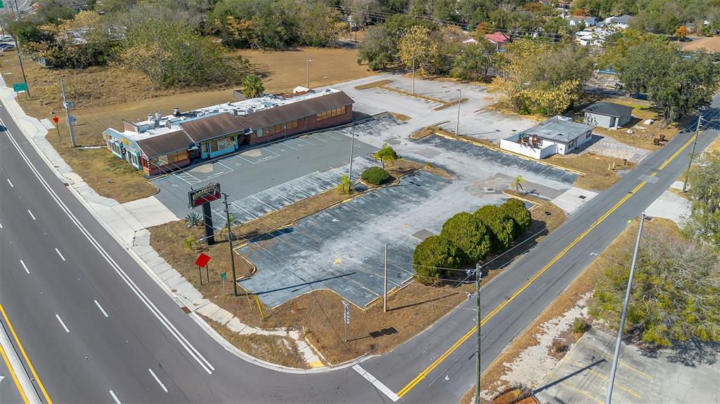 An aerial view shows a vacant commercial building with a large parking lot — 210 STATE ROAD 60 W, LAKE WALES, FL