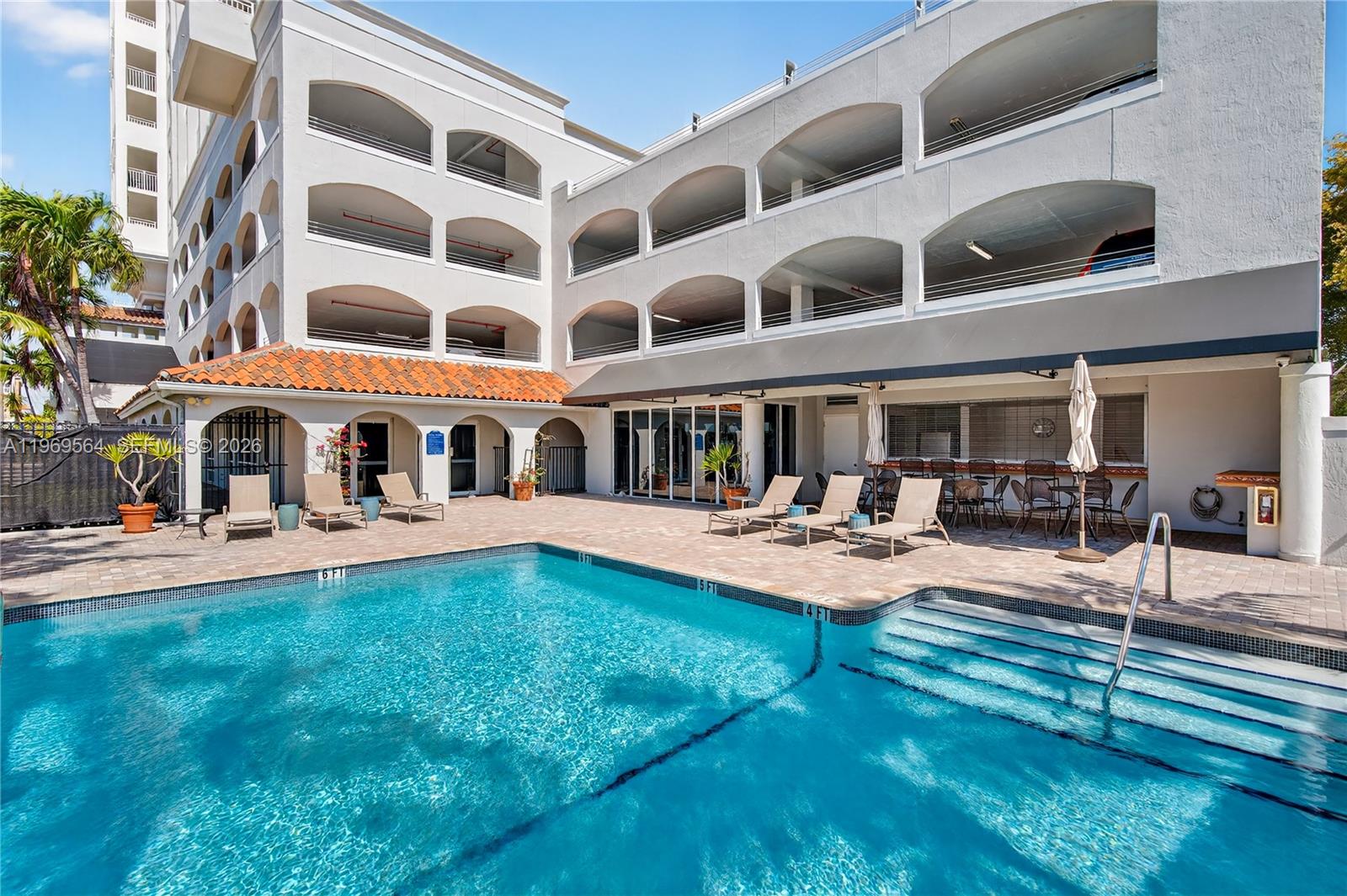 A kitchen features white cabinets, granite countertops, stainless steel appliances, and a tile floor — 2351 Douglas Rd # 1104, Miami FL 33145, MIAMI, FL