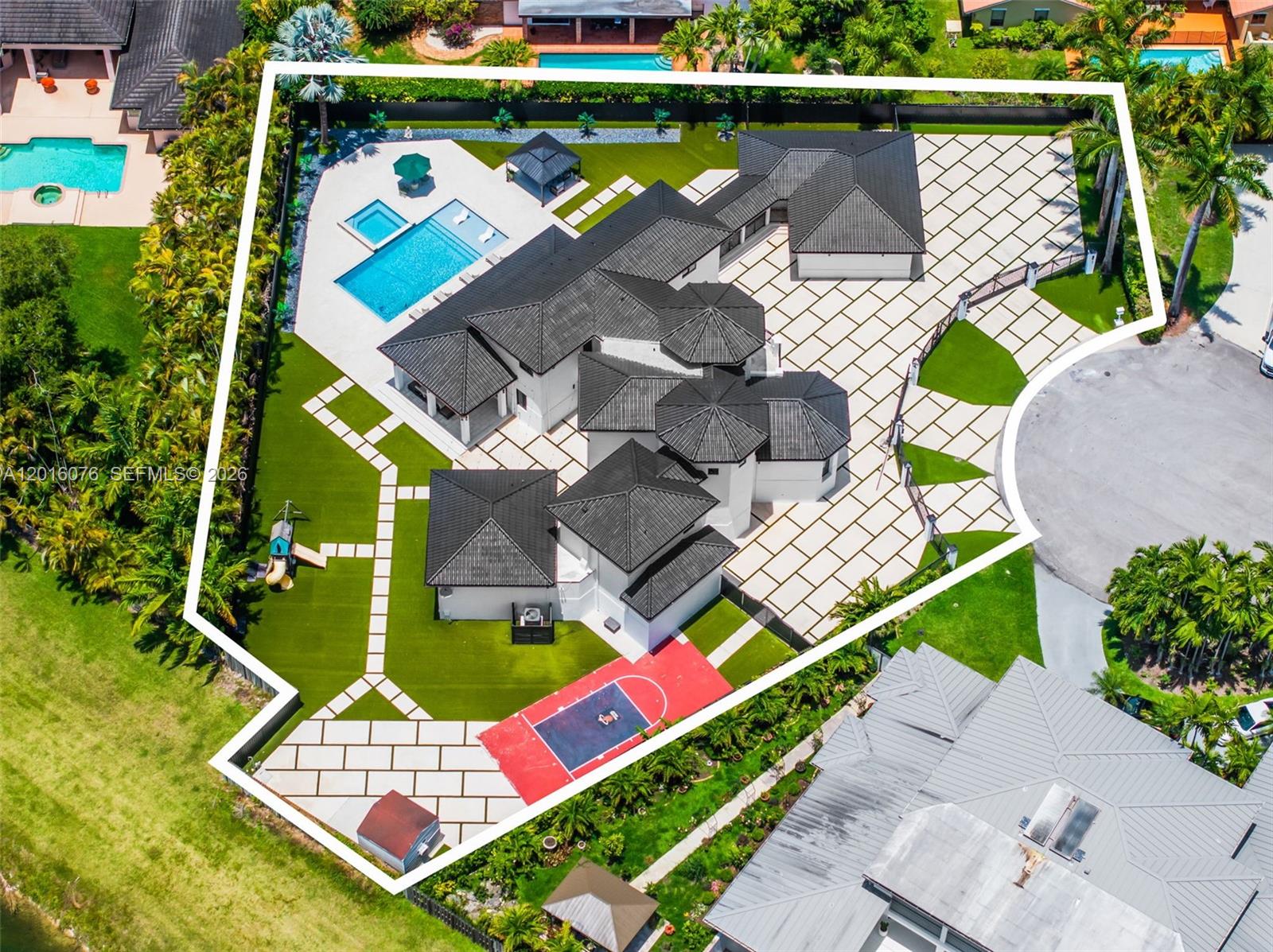 An aerial view shows a large house with a pool, basketball court, and paved driveway — 9881 SW 148th Ter, Miami FL 33176, MIAMI, FL