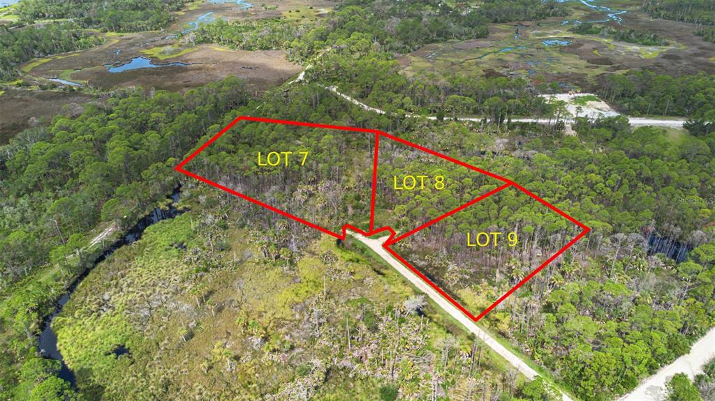 An aerial view shows three wooded land parcels outlined in red along a dirt road — Lot 8 SW 104 STREET, CEDAR KEY, FL