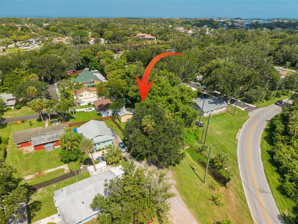An aerial view shows a residential neighborhood with a red arrow pointing to a house — 5721 CASSON AVENUE, NEW PORT RICHEY, FL