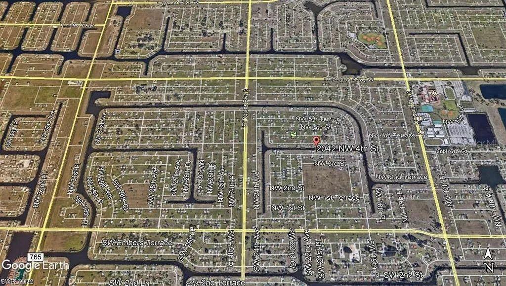 This is an aerial map view of a residential neighborhood with a marked location — 2042 NW 4TH STREET, CAPE CORAL, FL
