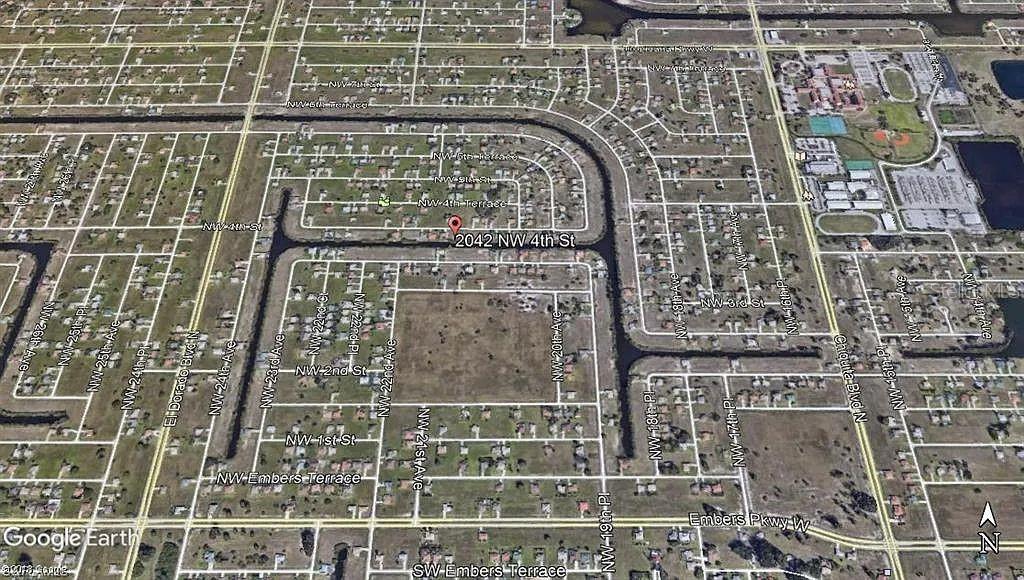 This is an aerial map view of a residential neighborhood with a marked property location — 2042 NW 4TH STREET, CAPE CORAL, FL