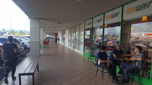 A covered outdoor walkway features a Subway restaurant with customers seated at tables outside — 1 PR-1 INT. LEONICIO VELAZQUEZ, CAGUAS, PR