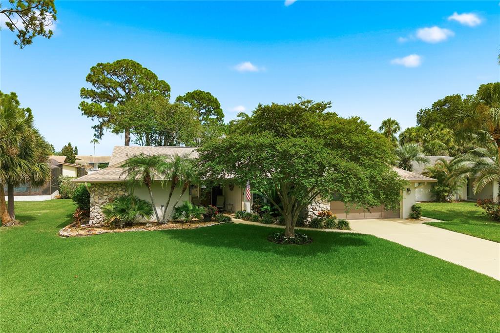 A single-story house with a two-car garage, stone accents, and a concrete driveway — 5468 NIMITZ ROAD, NEW PORT RICHEY, FL
