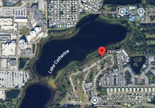 This is an aerial map view showing a lake and surrounding residential streets and buildings — 2441 BARKWATER DRIVE UNIT 26A, ORLANDO, FL