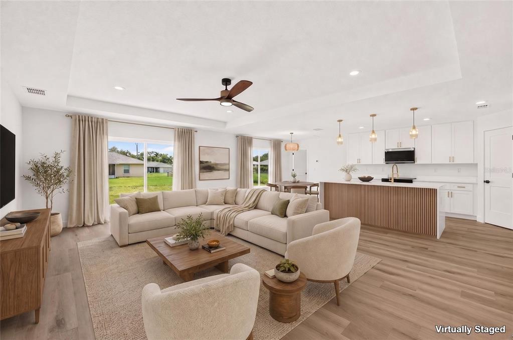 This is a virtually staged rendering of an open-concept living room and kitchen area — 4252 SE 135 LANE, SUMMERFIELD, FL