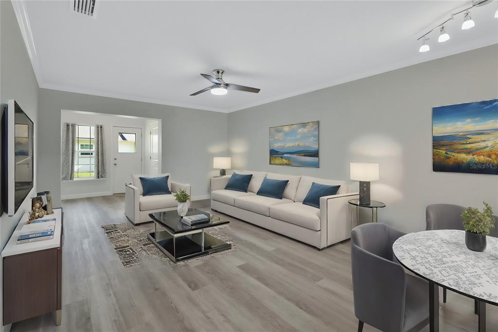 A living room features light gray flooring, a white sofa, and a dining table — 217 N HILL AVENUE UNIT 20, DELAND, FL