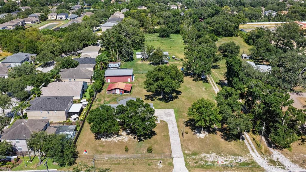 An aerial view shows a residential property with a house, outbuildings, and a large yard — 5604 WATSON ROAD, RIVERVIEW, FL