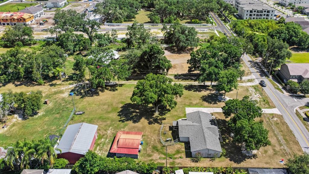 An aerial view shows a residential lot with a house, two outbuildings, and mature trees — 5604 WATSON ROAD, RIVERVIEW, FL