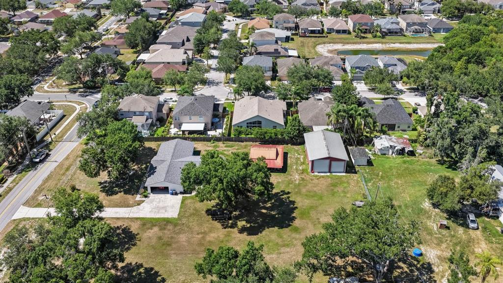 An aerial view shows a residential property with a house, detached garage, and large yard — 5604 WATSON ROAD, RIVERVIEW, FL