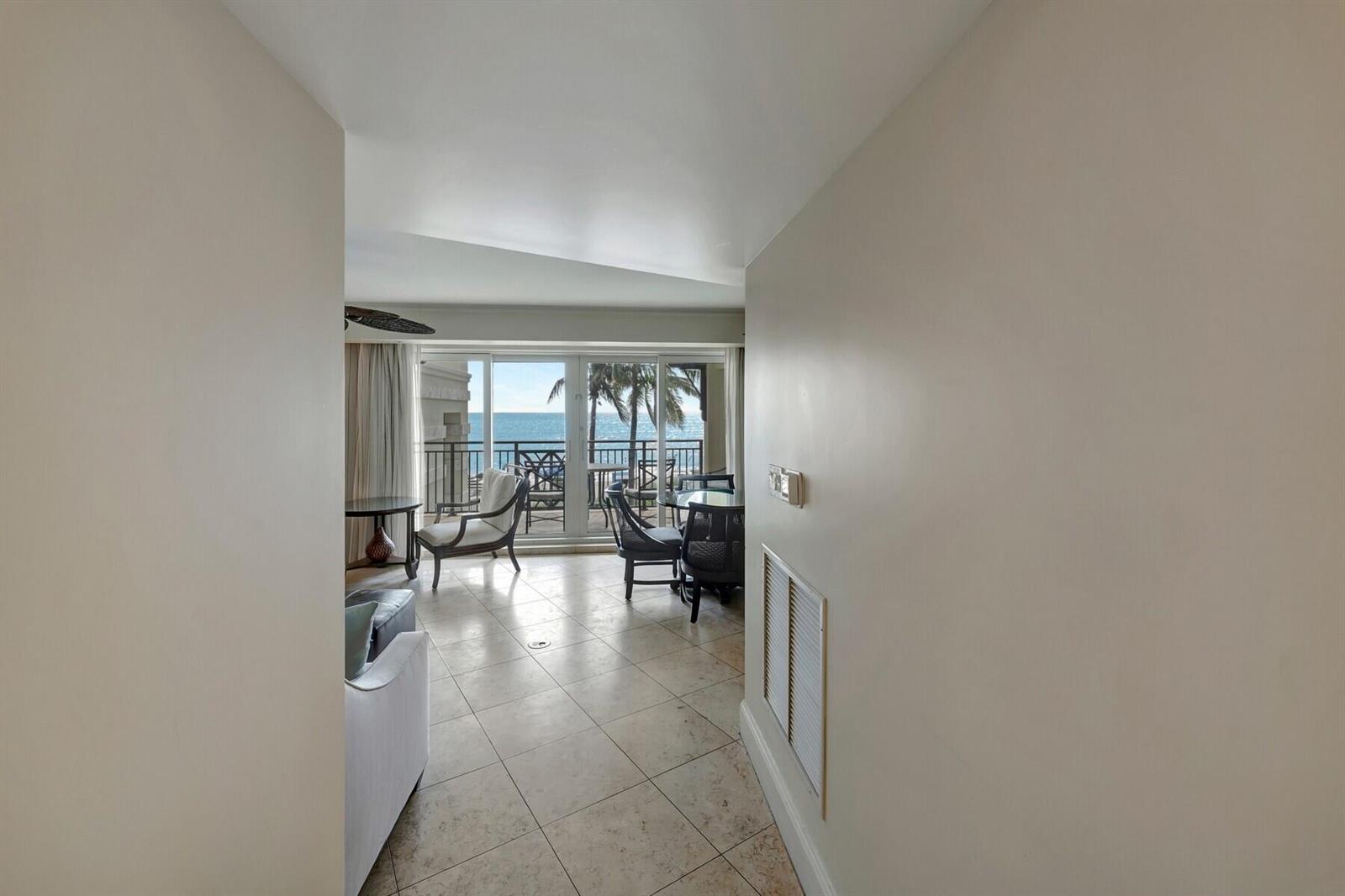 A tiled hallway leads into a living area with a balcony overlooking the ocean — 3500 Ocean Drive # 306, Vero Beach FL 32963, VERO BEACH, FL