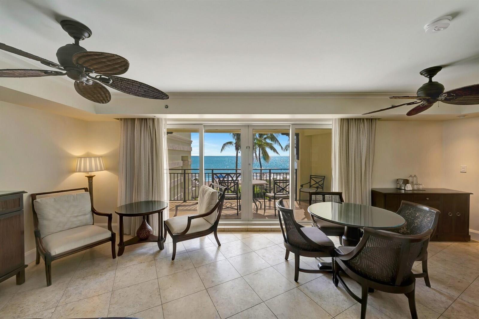 A hotel room with a dining area, seating, tile floors, and a balcony overlooking the ocean — 3500 Ocean Drive # 306, Vero Beach FL 32963, VERO BEACH, FL